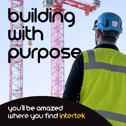 A construction engineer looking at a pair of building cranes